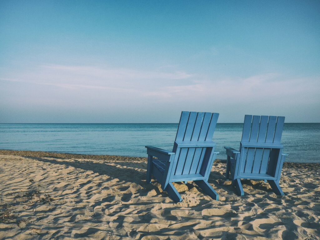 transition to retirement-2 beach chairs by the calm sea
