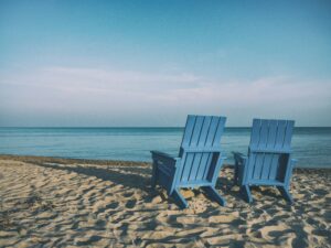 transition to retirement-2 beach chairs by the calm sea