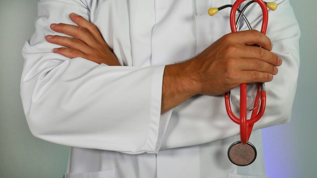 Retiring abroad-a medical professional with arms crossed holding a stethoscope