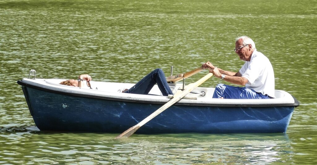 quiet retirement destinations- a senior couple in a rowboat on a lake